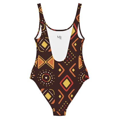 Maillot de bain imprimé wax une pièce Mod-ee, présentant une coupe ajustée et un dos plongeant, réalisé dans un matériau extensible pour un maintien optimal et un confort raffiné lors de vos activités aquatiques.