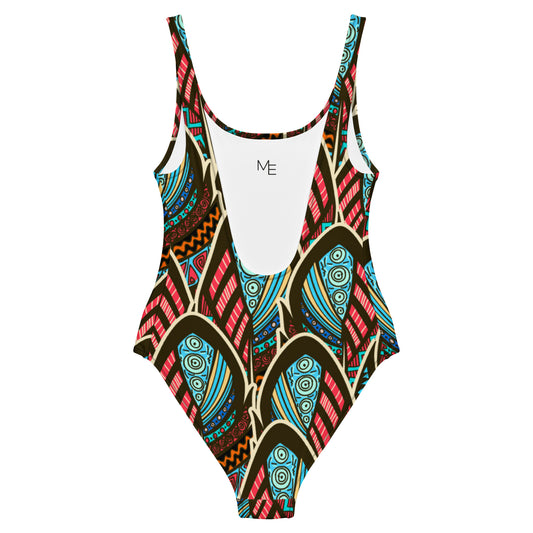 Maillot de bain imprimé wax une pièce Mod-ee, présentant une coupe ajustée et un dos plongeant, réalisé dans un matériau extensible pour un maintien optimal et un confort raffiné lors de vos activités aquatiques.